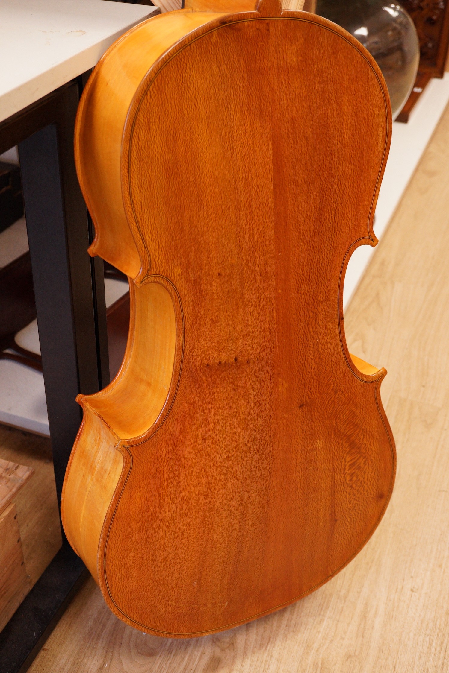 A cello and bow, back measures 73cm